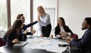Business team celebrating during a collaborative meeting, reflecting the productive teamwork supported by ManageCasa’s property management platform.
